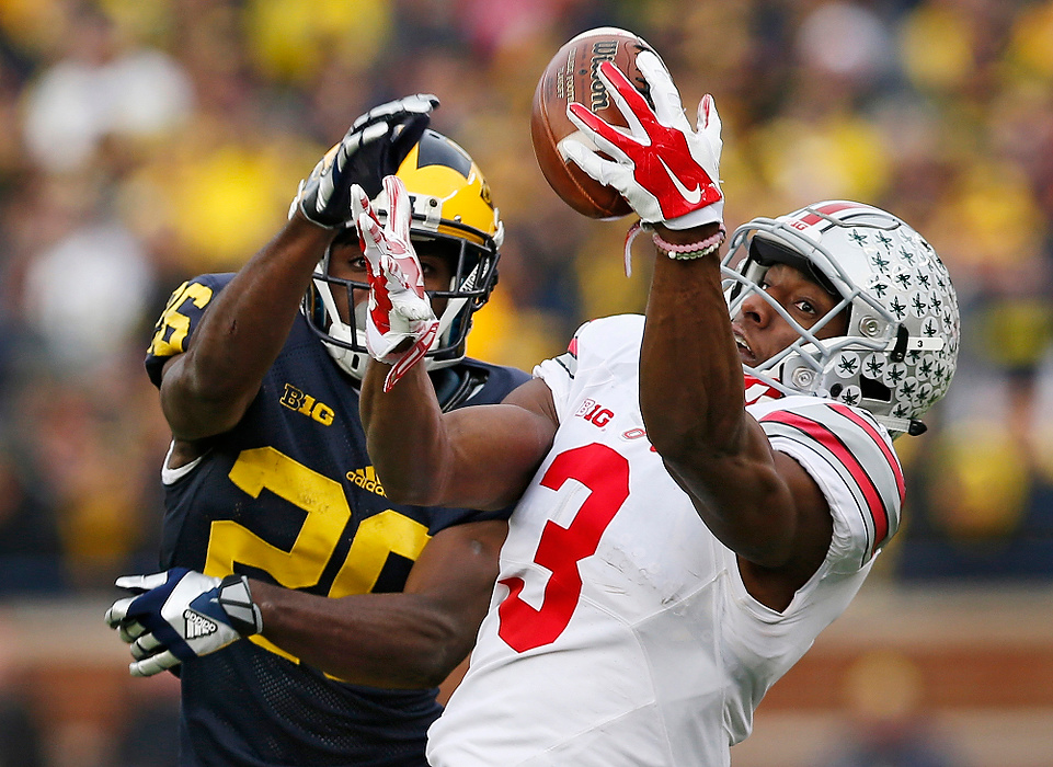 Second Place, Photographer of the Year - Large Market - Adam Cairns / The Columbus DispatchOhio State Buckeyes wide receiver Michael Thomas (3) catches a pass behind Michigan Wolverines cornerback Jourdan Lewis (26) during the fourth quarter of the NCAA football game at Michigan Stadium in Ann Arbor on Nov. 28, 2015. Ohio State won 42-13. 