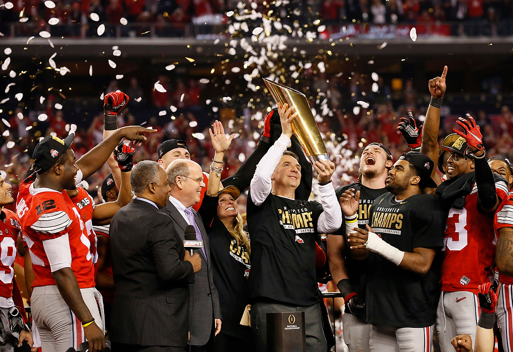 Second Place, Photographer of the Year - Large Market - Adam Cairns / The Columbus DispatchOhio State Buckeyes head coach Urban Meyer hoists the trophy following their 42-20 win over Oregon in the College Football Playoff National Championship at AT&T Stadium in Arlington, Texas on Jan. 12, 2015.