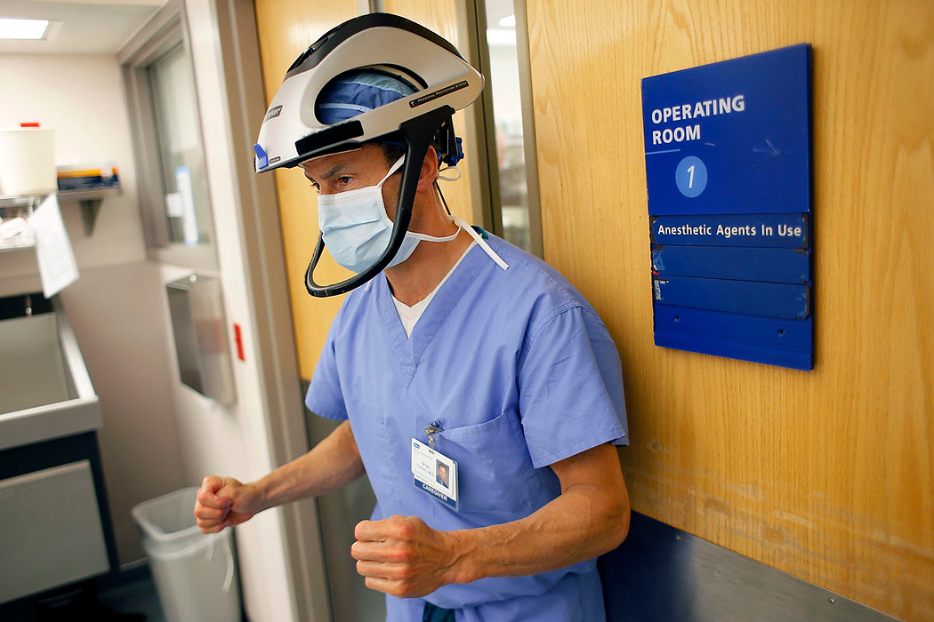 Second Place, Photographer of the Year - Large Market - Adam Cairns / The Columbus DispatchOrthopedic surgeon Brian Cohen enters the operating room at Adena Health System before a knee surgery in Chillicothe on June 10, 2015. The helmet helps protect from the bone saw.