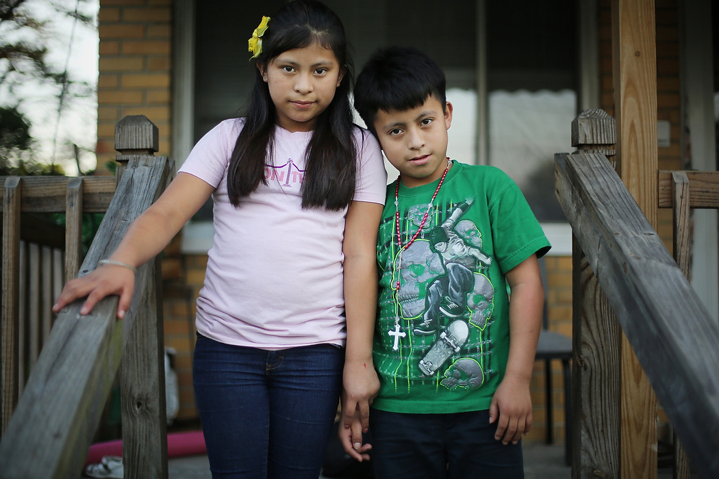 First Place, Photographer of the Year - Large Market - Carrie Cochran / Cincinnati EnquirerLindy Reynoso, 12, and her brother Yifry, 10, are photographed on their West Price Hill porch. Lindy and Yifry, who crossed the border in April 2014, found out that their immigration case was closed in the beginning of this year. They are in limbo. Although they were not deported, they did not gain a path to residency or citizenship.Their siblings, all of whom are younger and were born in the U.S., are U.S. citizens.