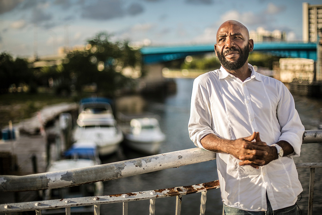 First Place, Photographer of the Year - Large Market - Carrie Cochran / Cincinnati EnquirerYvens Bernard, the father of Cincinnati Bengals running back Giovani Bernard, is photographed near the spot where he landed in a small fishing boat on the Miami River in Miami. He spent several days at sea, fleeing Haiti, not knowing if he would survive.