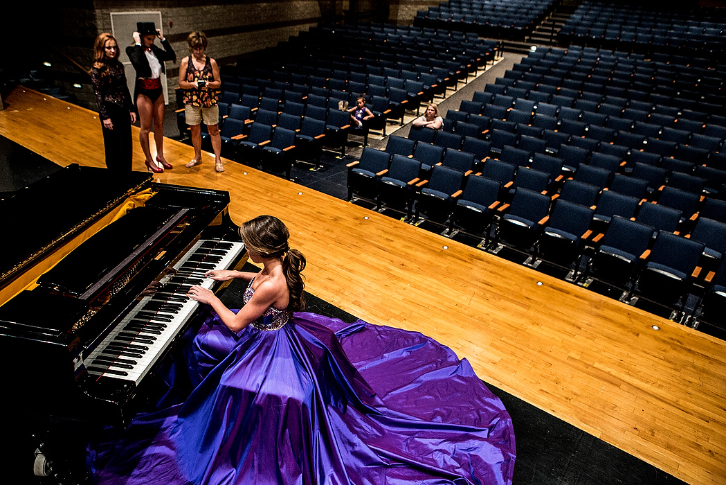 First Place, Photographer of the Year - Small Market - Jessica Phelps / Newark AdvocateAmelia, Katie and their mom, Gina Hitchens, watch as Abbey Hitchens practices for her talent portion of the pageant on the piano in the Granville High School Auditorium. The sisters were all practicing for their talent performances to get the feel of being on stage ahead of the Miss Ohio pageant. 