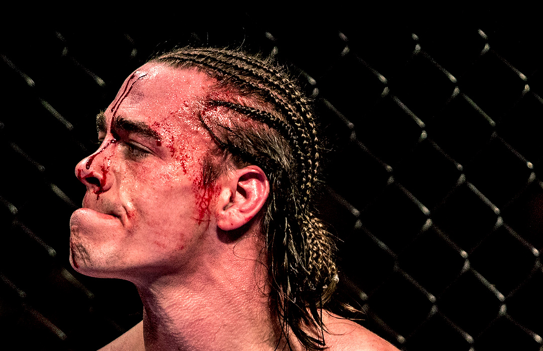 First Place, Photographer of the Year - Small Market - Jessica Phelps / Newark AdvocateRJ Hickey, bloody after a loss 48 seconds into the second round of an MMA fight against Tommy Metzger, pauses before being cleaned up by his coaches.