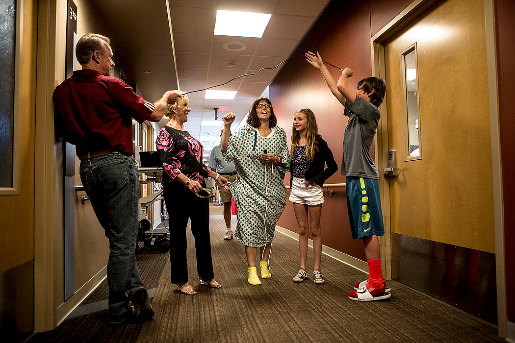 First Place, Photographer of the Year - Small Market - Jessica Phelps / Newark AdvocateStacey took her second walk through the hospital hallways when her family came to visit. As she neared her room, Darin and Noah ran ahead to hold a finish line up to encourage Stacey. 