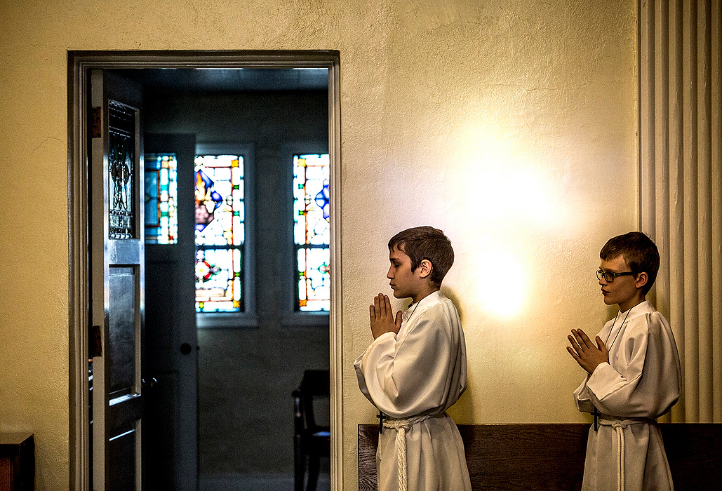 First Place, Photographer of the Year - Small Market - Jessica Phelps / Newark AdvocateEd Jewett and Mathew Smith assist Father Wilson as alter boys at Blessed Sacrament. Father Wilson held a special Lenten Mass for the students before Holy week began. 