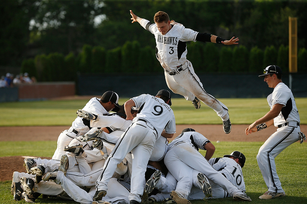 Award of Excellence, Sports Feature - Eamon Queeney / The Columbus DispatchWesterville Central junior Jeremiah Clarke (3) leaps onto the dog pile as the Warhawks celebrate their victory over Olentangy Liberty in the Division I regional championship at Dublin Coffman High School. 