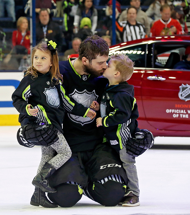 First Place, Ron Kuntz Sports Photographer of the Year - Barbara J. Perenic / The Columbus DispatchTeam Foligno defender Brent Burns (San Jose Sharks) (88) holds his children Payton, left, and Jagger, right, on the ice following the NHL All-Star Game at Nationwide Arena in Columbus on Sunday, January 25, 2015. 