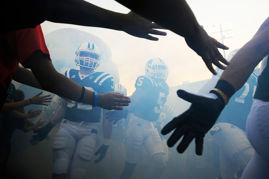 Second Place, Ron Kuntz Sports Photographer of the Year - Logan Riely / Ohio UniversityThe Ohio Bobcat football team take to the field while running through smoke against the University of Idaho for their home opener at Peden Stadium on Sept. 20, 2014.