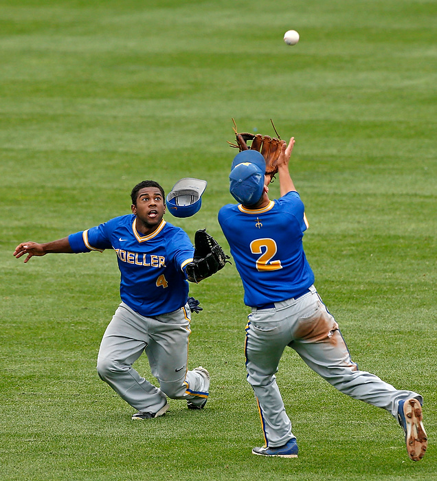 First Place, Ron Kuntz Sports Photographer of the Year - Barbara J. Perenic / The Columbus DispatchJordan Ramey (4) and Kyle Dockus (2) of Moeller both reach for a fly ball in the outfield during Saturday's Division I state baseball championship game against Westerville Central at Huntington Park on June 6, 2015. 