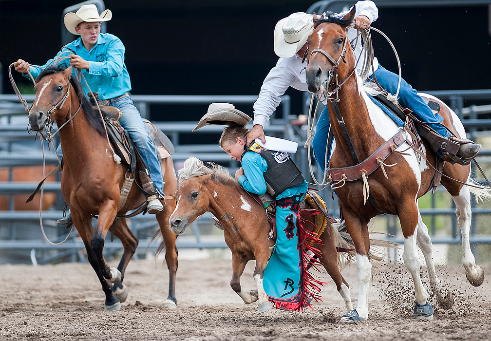 Second Place, Ron Kuntz Sports Photographer of the Year - Logan Riely / Ohio UniversityA youth bareback rider receives help before falling off his horse during the first ever Mini Bareback Riding World Championship Semifinals held at the ProRodeo Hall of Fame arena in Colorado Springs, Colorado on Oct. 7, 2015. Twenty of the best - and youngest - regional competitors put their bucking skills to the test for the chance to advance to the World Championships in Las Vegas in December.