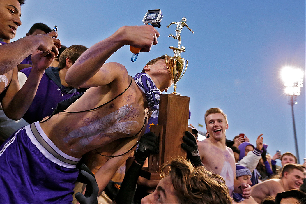 First Place, Ron Kuntz Sports Photographer of the Year - Barbara J. Perenic / The Columbus DispatchA St. Francis DeSales student kisses the trophy while filming with a GoPro while the team celebrated a 1-0 win over Bay Village during Saturday's OHSAA Division II state championship soccer game at Mapfre Stadium in Columbus on November 14, 2015. 