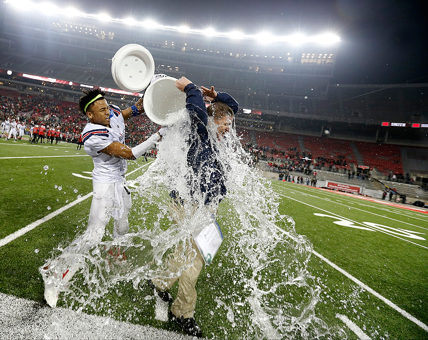 First Place, Ron Kuntz Sports Photographer of the Year - Barbara J. Perenic / The Columbus DispatchBishop Hartley head coach Brad Burchfield is doused with ice water by Rian Anderson (2) as time expires in Saturday's OHSAA Division IV state championship football game against Steubenville at Ohio Stadium in Columbus on December 5, 2015. Hartley won the game 31-28. 
