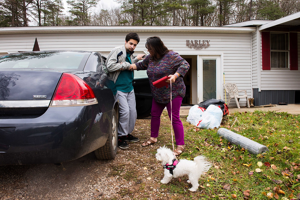 First Place, Student Photographer of the Year - Isaac Hale / Ohio UniversityMichele helps Bubba into the car to go visit his stepfather, Duey, at the SEPTA Correctional Facility while she handles Emily, their pet and service dog.