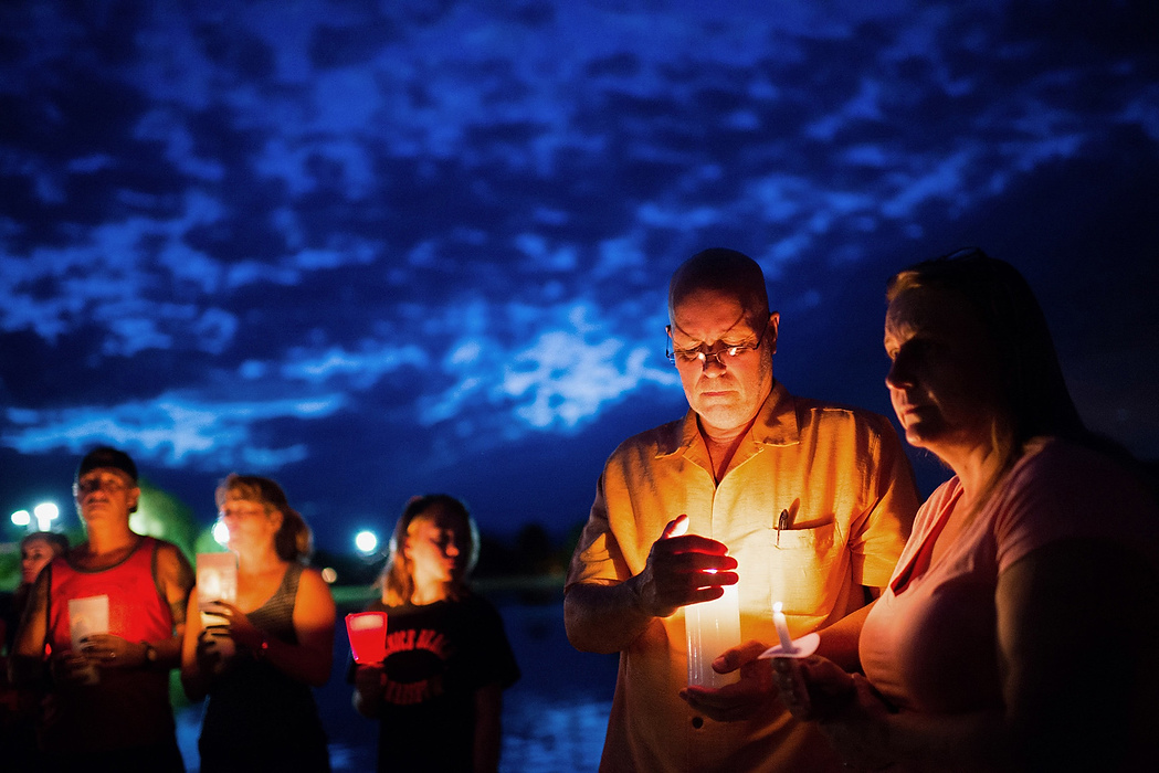 First Place, Student Photographer of the Year - Isaac Hale / Ohio UniversityBarbara and Derek Habbeshaw, right, listen to a pastor speak during the candlelight vigil for Michael and Tina Careccia at Pacana Park in Maricopa, AZ, on Friday, July 3, 2015. Jose Valenzuela confessed to shooting the couple after police found their bodies buried in his yard.