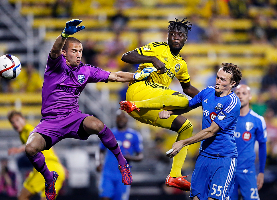 , Student Photographer of the Year - Eli C. Hiller / Ohio UniversityColumbus Crew SC forward Kei Kamara (23) leaps for the shot as Montreal Impact goalkeeper Evan Bush (1) and Montreal Impact defender Wandrille Lefevre (55) try to stop him during the second half of the game at Mapfre Stadium in Columbus, Ohio, on June 6, 2015. The Crew lost the game 0-2.