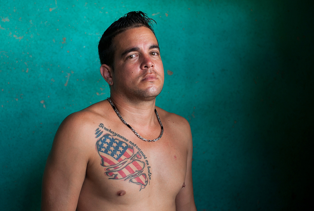 , Student Photographer of the Year - Eli C. Hiller / Ohio UniversityYordanis García, 32 of Havana, left for Cuba over a year ago after spending several months working in Ecuador to save money for his trip north. His tattoo reads “Si no hay carro nos vamos en balsa,” (If there’s not a car, we’ll raft), a lyric in Spanish that is spoken by Cuban-American rapper Pitbull in the song “Rain Over Me.” “The phrase is a way to protest because to own a car in Cuba is very expensive," said García. "We don’t migrate only for freedom, but also for economic and political problems. Political for the king that we currently have and economic because in the end they don’t pay us what they owe us." Cuba’s National Statistics and Information Bureau (ONEI) in 2012 reported that the average monthly wage for Cubans is equivalent to US $20. 