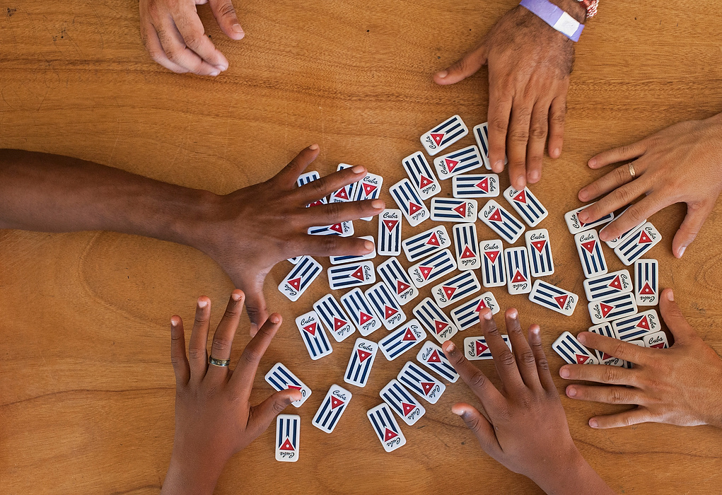 , Student Photographer of the Year - Eli C. Hiller / Ohio UniversityHands of Cuban migrants Yasiel Valero, Elier Becker, Arnnier Dranguet, and Raymel Escobar reach for domino pieces to start a game in a shelter in La Cruz. Dominoes is a classic game in Cuba that people of all ages and backgrounds frequently play. 