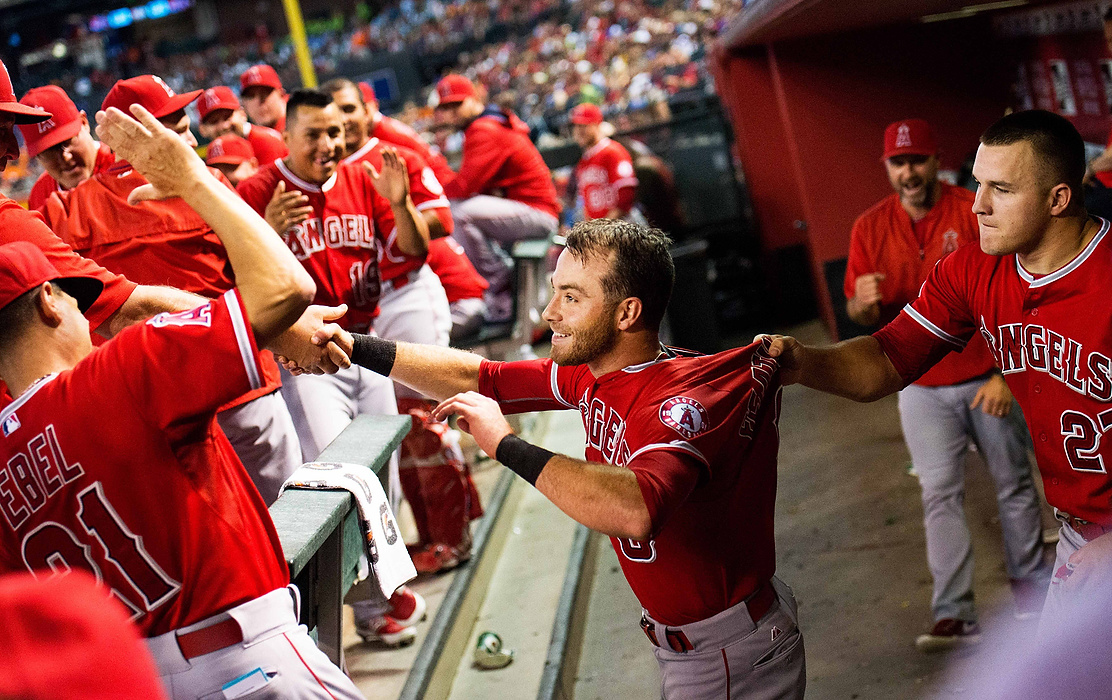 First Place, Student Photographer of the Year - Isaac Hale / Ohio UniversityThird baseman Taylor Featherston, center, is congratulated by his teammates in the dugout after scoring a run in the first inning, the first home run of his major-league career. The Los Angeles Angels defeated the Arizona Diamondbacks 7-1 at Chase Field in Phoenix, AZ, on Thursday, June 18, 2015.