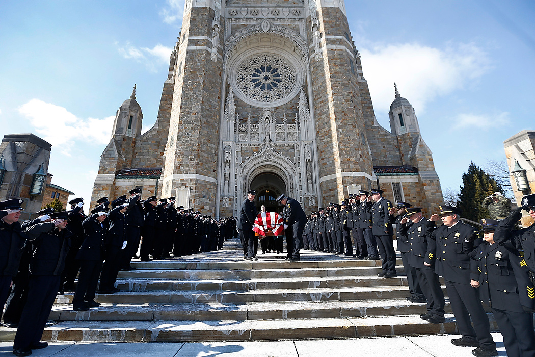 First Place, Team Picture Story - Amy E. Voigt / The (Toledo) BladePolice line the steps as the casket of Mayor D. Michael Collins is carried to the hearse following the funeral mass at Our Lady Queen of the Most Holy Rosary Cathedral.  Collins was a former Toledo police officer.