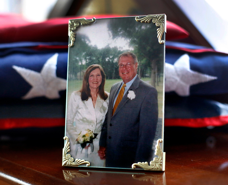 First Place, Team Picture Story - Amy E. Voigt / The (Toledo) Blade A wedding portrait of Sandy Drabik and her late husband Mayor D. Michael Collins, is displayed in their home, next to the flag which draped his casket during the funeral.