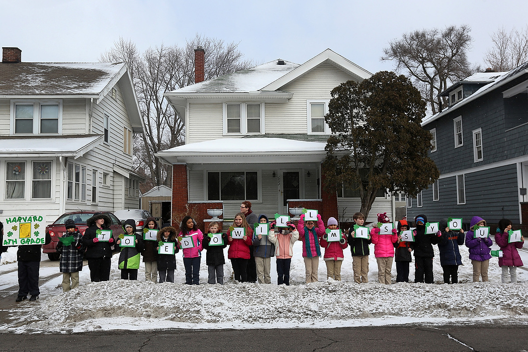 First Place, Team Picture Story - Katie Rausch / The (Toledo) BladeMrs. Michele Pass' fourth grade class from Harvard Elementary School raise handmade signs that spell out, "Toledo Will Miss You!" during the funeral processional for Toledo Mayor D. Michael Collins as it passes near Wixey Bakery in South Toledo on Thursday, February 12, 2015. After winding its way through the city, the processional ended at Toledo's Rosary Cathedral for a funeral Mass.  