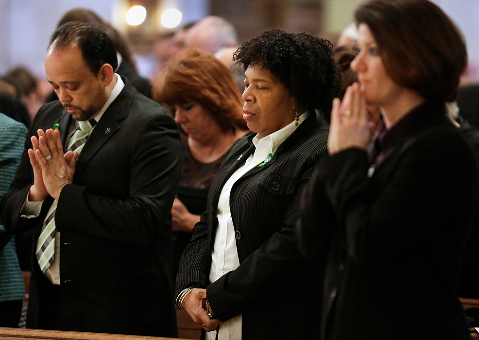 First Place, Team Picture Story - Andy Morrison / The (Toledo) BladeActing Mayor Paula Hicks-Hudson, center, prays with others during a funeral service for Mayor D. Michael Collins at Our Lady Queen of the Most Holy Rosary Cathedral, Thursday, February 12, 2015. 