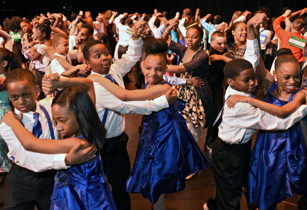 Third Place, Feature - Peggy Turbett / FreelanceFifth-grade ballroom dance teams from 12 schools warm up with a tango at the Colors of the Rainbow Grand Finals, part of the Dancing Classrooms Northeast Ohio program, on stage at the Ohio Theatre. 