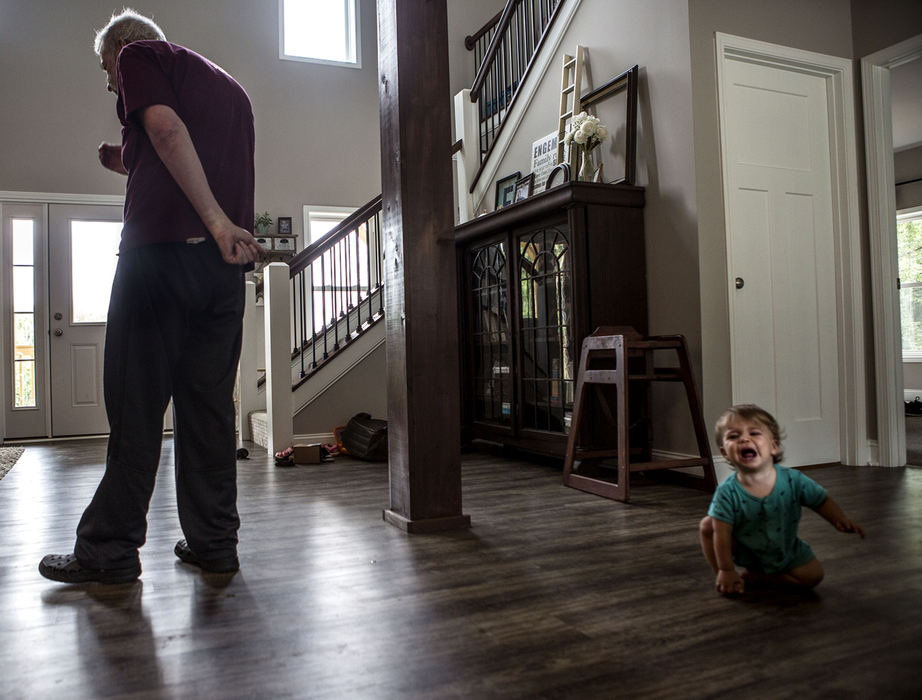 Second Place, Feature Picture Story - Jessica Phelps / Newark AdvocateTom wanders aimlessly through the house not recognizing that a baby is crying, and that the baby is his 12 month old grandson, David. “It’s heartbreaking to get frustrated too because we know it’s not his fault,” Abby said. 