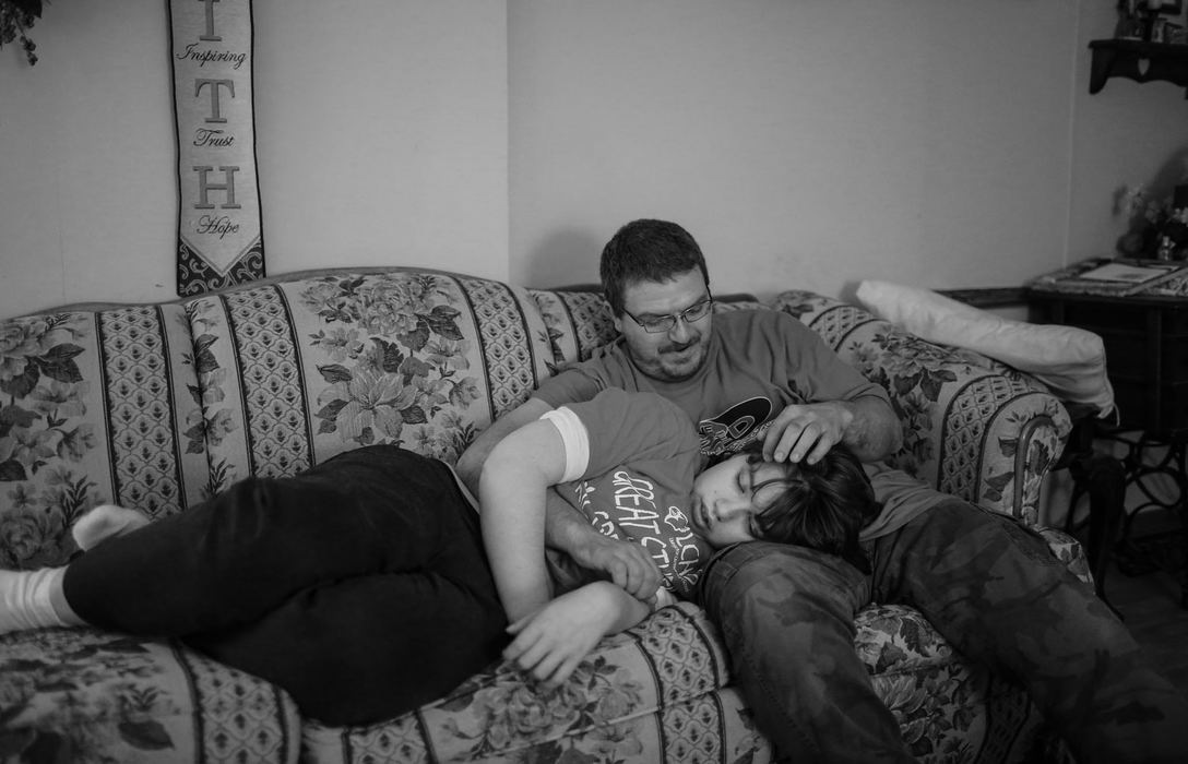 Third Place, Feature Picture Story - Andrea Noall / Kent State UniversityJeffery strokes his daughter's hair as she falls asleep on his lap after a long day at school on Friday, October 21, 2016. "Haley has always been a daddy's girl. You can easily tell who the favorite is when he's around," her grandmother, Nora, said. 