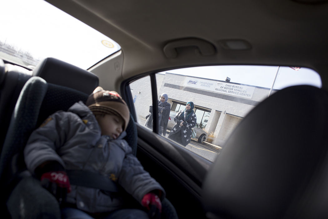 Award of Excellence, Feature Picture Story - Eslah Attar / Kent State UniversityTwo year-old Mohamad sleeps in the car as his mother Mariam and Runah, a volunteer for Salaam Cleveland, leave the Bureau of Motor Vehicles after Mariam recieved news that she failed her driver's permit exam on Wednesday, Dec. 7, 2016. 