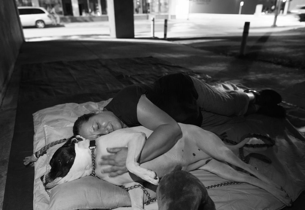 First Place, Feature Picture Story - Andy Morrison / The (Toledo) BladeDiann Wears cuddles her dog Cow as they lay down to go to sleep at the old Greyhound Terminal at Jefferson Avenue and Michigan Street. The pair were back on the street after staying in a hotel for a week.  