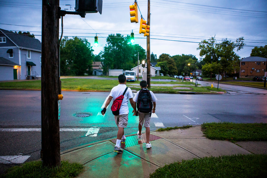 Second Place, James R. Gordon Ohio Understanding Award - Meg Vogel / Cincinnati EnquirerHasan and Hussein Alhamoud cross the street to catch their bus to Withrow University High School on Wednesday, August 17, 2016. The brothers want to be dentists. As the oldest, the boys help translate for their parents. Ahlam said, "With the days passing, the boys are forgetting and moving on. I do not want them to forget Syria, but I want them to forget what happened in Syria." 