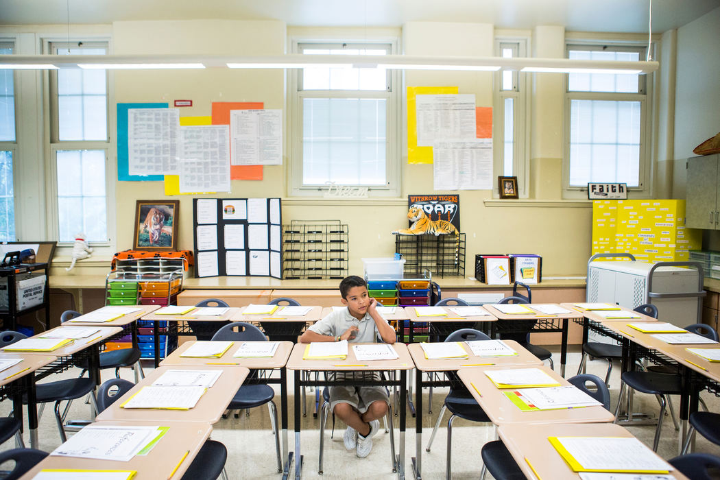 Second Place, James R. Gordon Ohio Understanding Award - Meg Vogel / Cincinnati EnquirerHussein Alhamoud waits for his peers to arrive in class on the first day of school at Withrow University High School on Wednesday, August 17, 2016.