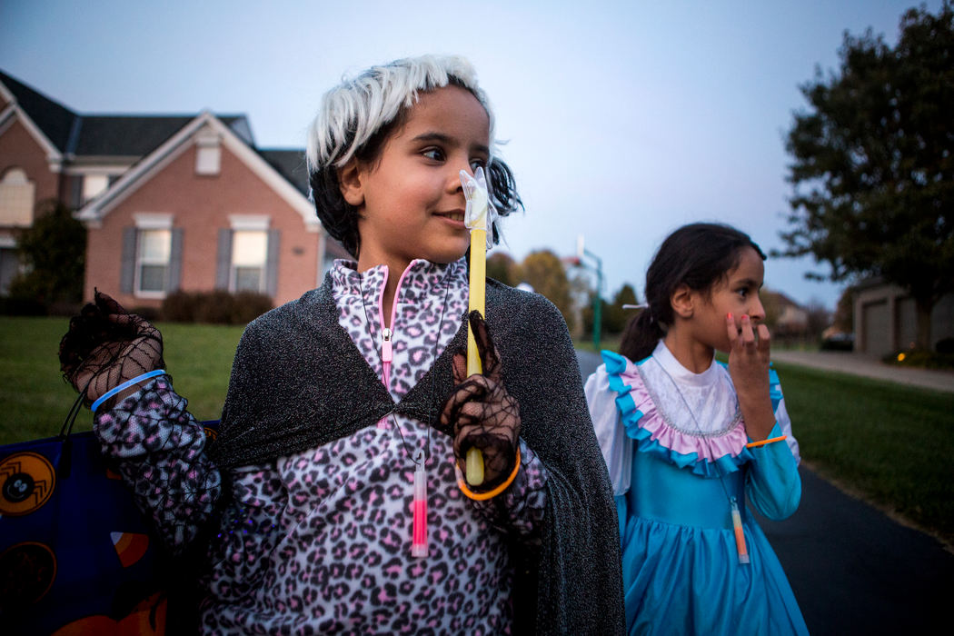 Second Place, James R. Gordon Ohio Understanding Award - Meg Vogel / Cincinnati EnquirerDalal Alhamoud waits to see which direction her brothers and sisters will go for trick-or-treating on Monday, October 31, 2016. It was the first time Dalal and her siblings celebrated Halloween. Volunteers donated costumes for the family.