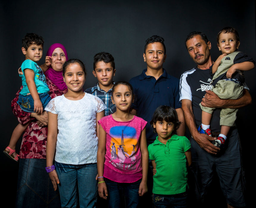 Second Place, James R. Gordon Ohio Understanding Award - Meg Vogel / Cincinnati EnquirerThe Alhamoud family poses for a portrait on Sunday, September 25, 2016. They arrived in the United States on October 19, 2015, from Jordan, where they sought refuge for several years after fleeing Syria. Back row from left to right: Ahlam (36), Ghalia (3), Hussein (12), Hasan(13), Marie (43) and Yousif (2). Front row from left to right: Dalal (9), Zina (7) and Rimas (5).  