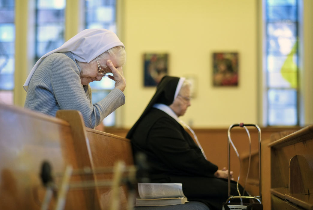 Third Place, Ohio Understanding Award - Andy Morrison / The (Toledo) BladeSr. Ethel Mary Camp, left, prays during morning mass at the the Sisters of Notre Dame Toledo Province.
