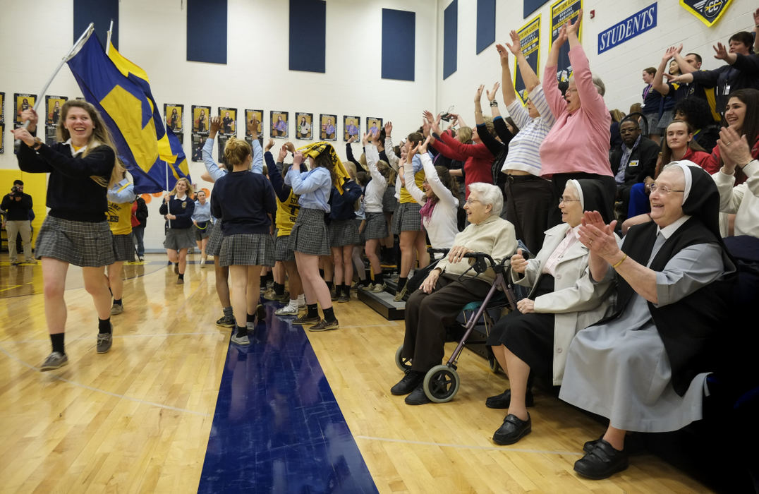 Third Place, Ohio Understanding Award - Andy Morrison / The (Toledo) BladeSr. Audrey Marie Kreuz, left, Sr. Rose Maria Moser, middle, and Sr. Alma Rose Langenderfer, right, sit with students at Notre Dame Academy during a during a pep rally before the basketball team heads to the state tournament.