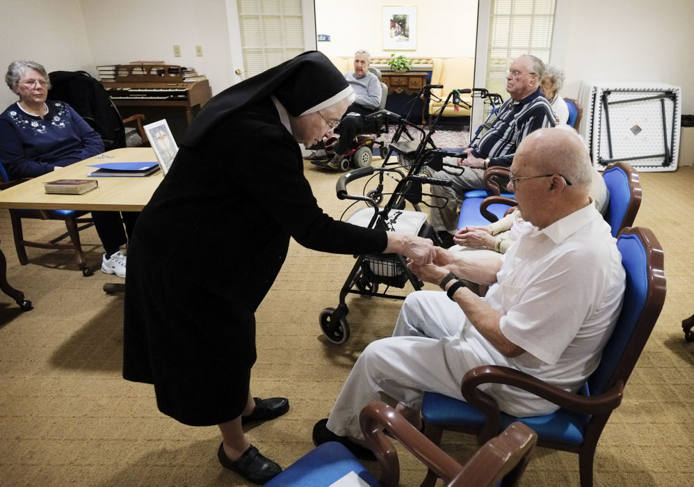Third Place, Ohio Understanding Award - Andy Morrison / The (Toledo) BladeSr. Rose Maria Moser, 91, gives communion to Tim Gormley, 82, and other residents at Kingston Care Center of Sylvania.