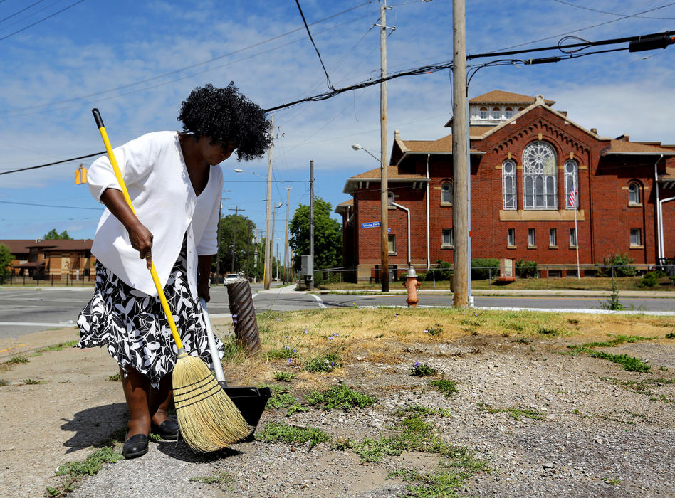 Award of Excellence, Ohio Understanding Award - Lisa DeJong  / The Plain Dealer"I can't change the world, but I can do something here. I can clean up the glass," says Pastor Elizabeth McComb, 63, as she sweeps the broken glass in the vacant lot beside her church, The First Church of Saint Luke, on the corner of Addison Road and Wade Park Avenue. McComb has been coming to the church for her entire 63 years.