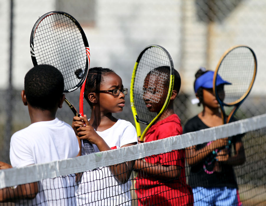 Award of Excellence, Ohio Understanding Award - Lisa DeJong  / The Plain DealerAniyah McPherson, 7, with glasses, lines up for drills during the Inner City Tennis Clinics summer camp on the tennis courts of Cleveland Thurgood Marshall Recreation Center in the Hough neighborhood. The  Inner City Tennis Clinics is a non-profit organization dedicated to providing urban youths with guidance, education and recreation during the summer months. 