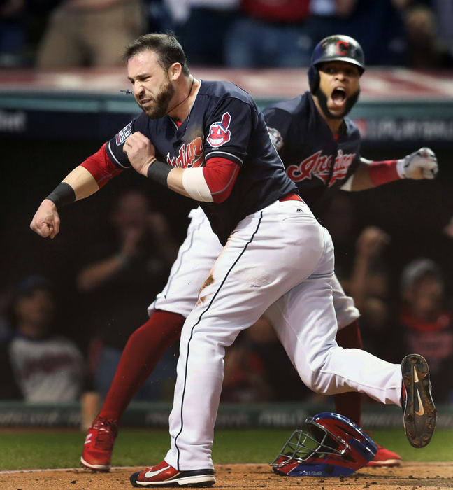 Award of Excellence, Photographer of the Year - Large Market - Gus Chan / The Plain DealerThe Cleveland Indians Jason Kipnis and Carlos Santana celebrate after both players scored on Chicago Cubs reliever Jon Lester's wild pitch in the fifth inning of Game 7 of the World Series.