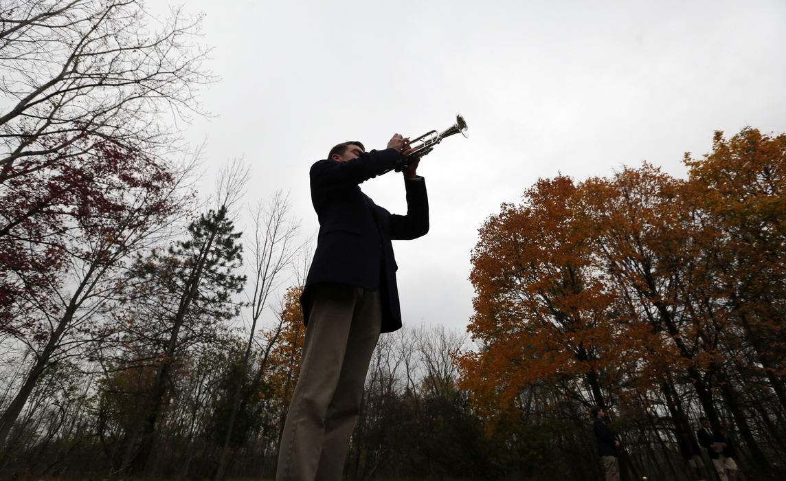 Award of Excellence, Photographer of the Year - Large Market - Gus Chan / The Plain DealerTom Filipovich plays taps at the Potter's Field Prayer Service October 31, 2015. Twice a year the Saint Joseph of Arimathea Pallbearers’ conduct a prayer service for the indigent buried at the City of Cleveland's Potter Field in Highland Hills. 