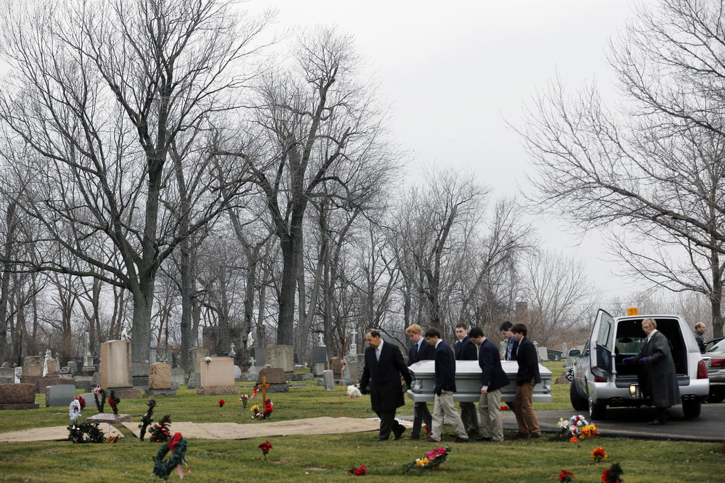 Award of Excellence, Photographer of the Year - Large Market - Gus Chan / The Plain DealerMembers of the St. Joseph of Arimathea Pallbearers carry the casket of Dorothy Umerley to the burial site at St. Mary's Cemetery. 