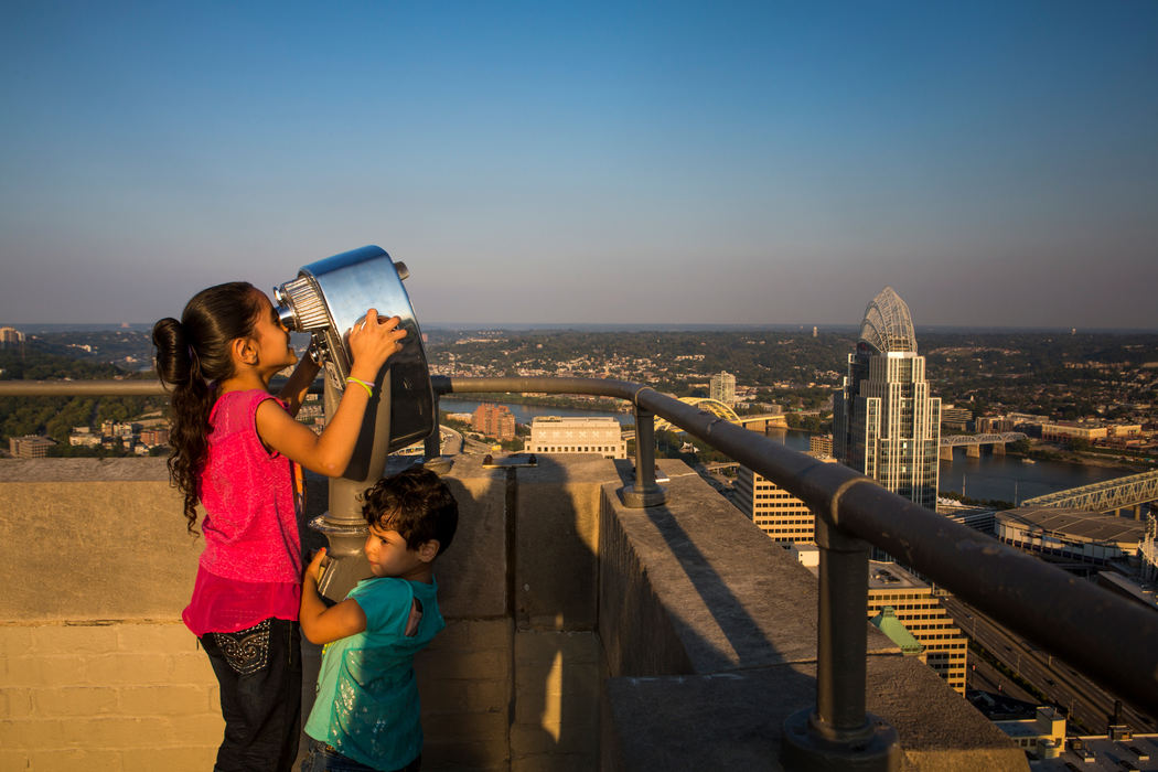 First Place, Photographer of the Year - Large Market - Meg Vogel / The Enquirer/Meg VogelZina and Ghalia Alhamoud looks at downtown Cincinnati from the top of Carew Tower on Sunday, September 25, 2016. Marie said, "The best thing in my life is watching my kids study and learn."