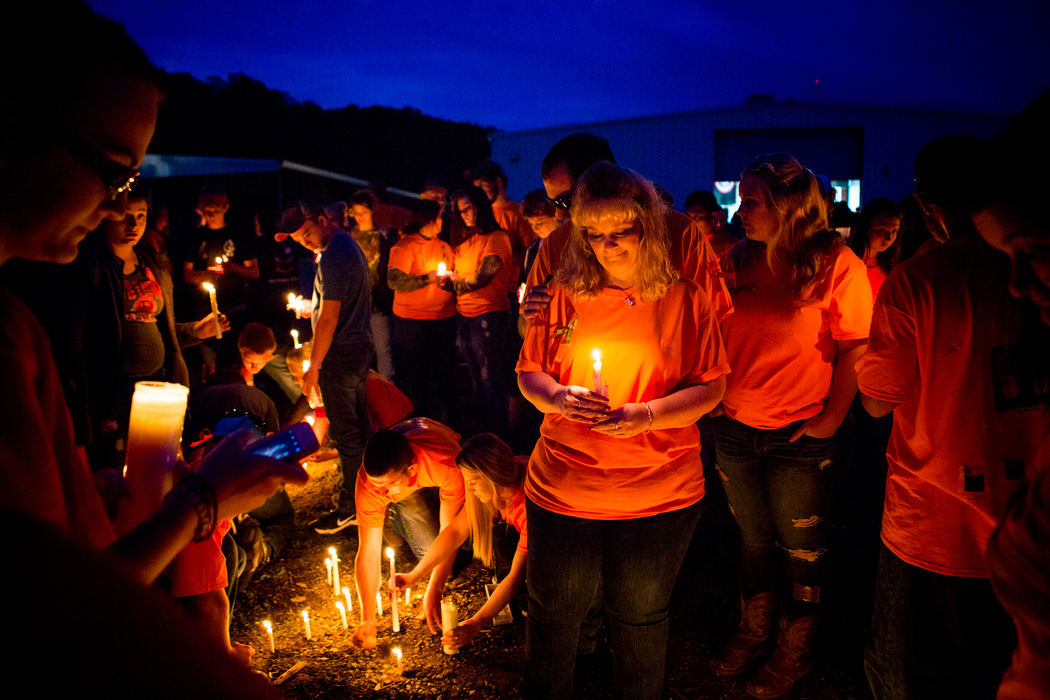 First Place, Photographer of the Year - Large Market -  / The Enquirer/Meg VogelAngela Musser Payne holds a candle at the “Pray for Pike County” vigil at the Pike County Fairgrounds Friday, April 29, 2016, to honor the eight victims from last week’s shootings. Payne was best friends with Dana Rhoden, who was among the deceased. The ongoing murder investigation is the largest in Ohio's history.