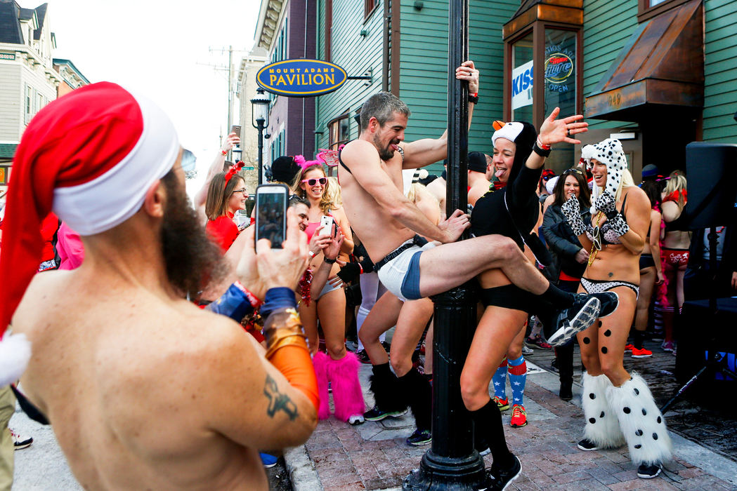 First Place, Photographer of the Year - Large Market -  / The Enquirer/Meg VogelA man dressed in a diaper dances with a woman dressed like a penguin, after the Cupid's Undie Run, which raised $64,000 for the Children's Tumor Foundation, in Mt. Adams Saturday, Feb. 13, 2016. Participants ran less than a mile in 17-degree weather in their underwear and costumes. 