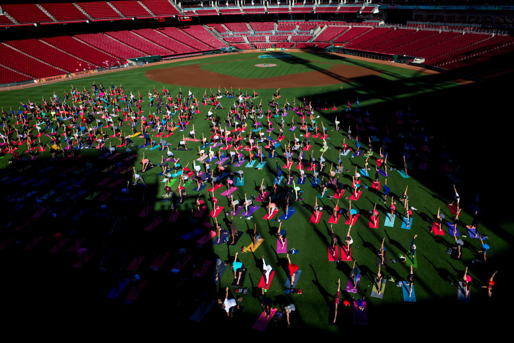 First Place, Photographer of the Year - Large Market -  / The Enquirer/Meg VogelMore than 500 people participate in an hour-long yoga session instructed by The Yoga Bar on the outfield grass at Great American Ball Park for "Sliding Into Om" Saturday, September 3, 2016. 