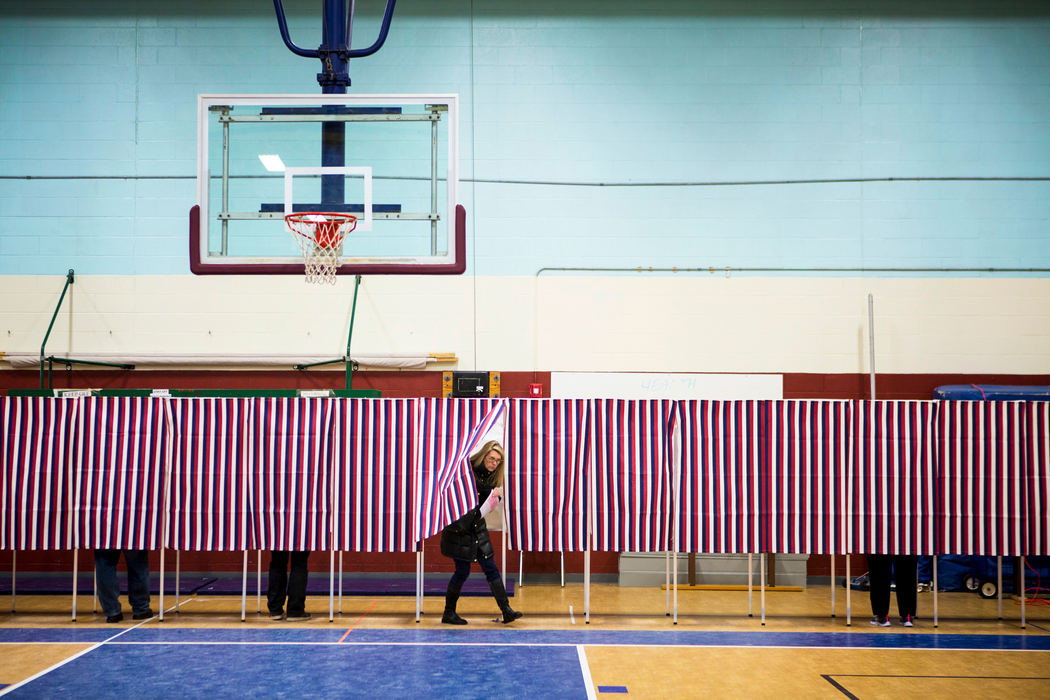 First Place, Photographer of the Year - Large Market -  / The Enquirer/Meg VogelVoters cast their ballots at the Concord ward two polling place at Broken Ground School in Concord, N.H. Tuesday, Feb. 9, 2016. Gov. Kasich comes in second place to Donald Trump and received four delegates. 