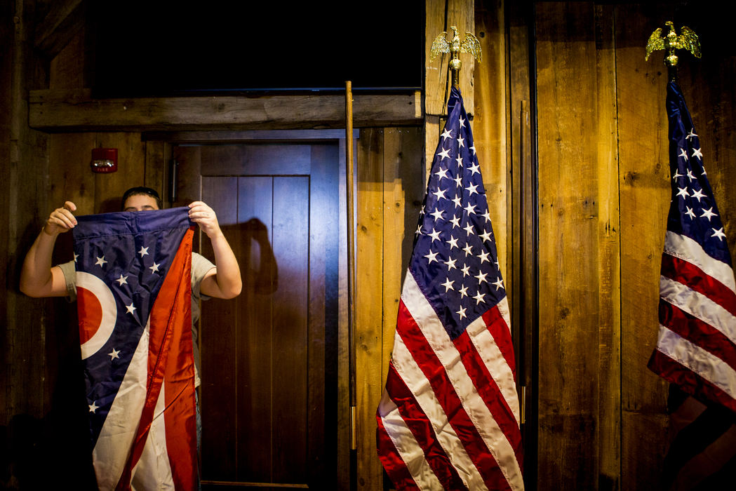 First Place, Photographer of the Year - Large Market -  / The Enquirer/Meg VogelA volunteer folds the flag of Ohio, after Gov. Kasich announced that he is suspending his GOP presidential run at a press conference at The Franklin Park Conservatory and Botanical Gardens in Columbus Wednesday, May 4, 2016.