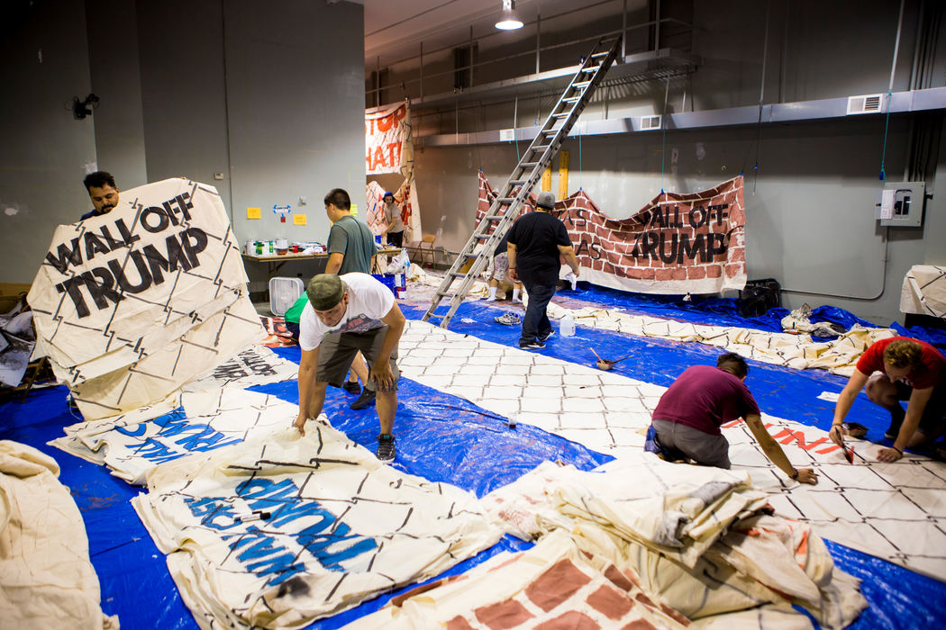 First Place, Photographer of the Year - Large Market -  / The Enquirer/Meg VogelVolunteers from around the county paint bricks and chain link designs on muslin ponchos that will be used to make a wall for a protest at the Republican National Convention in Cleveland, Ohio Tuesday, July 19, 2016.  They will create a human wall that will stretch about 1,000 feet to "Wall Off Trump."